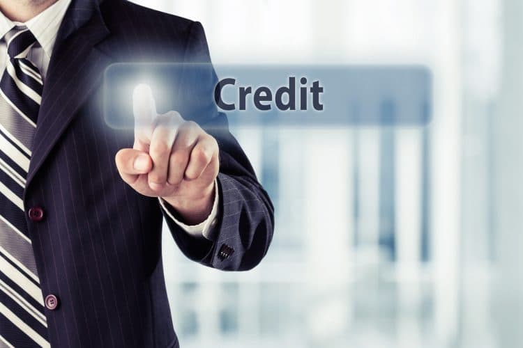 Businessman pressing Credit button at his office. Toned photo