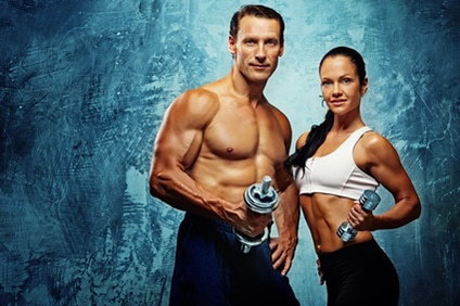 Athletic man and woman with a dumbells.